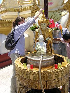 Cornelia pouring water on her Buddha